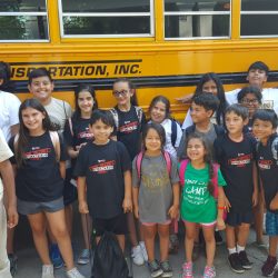 Kids beside the transportation bus